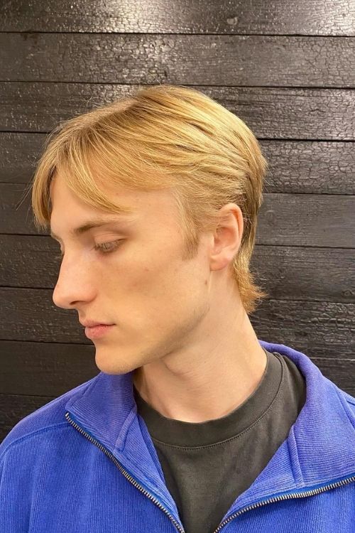 Blonde subtle mullet with soft layers and slightly tapered back