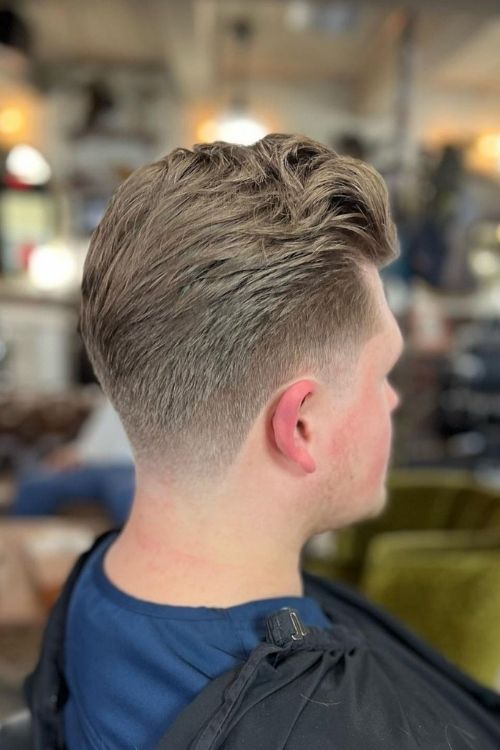 Short textured pompadour with a faded undercut light brown