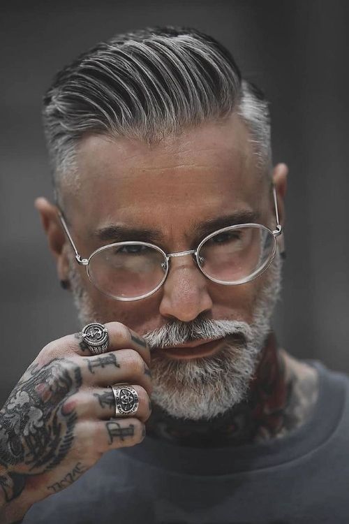 Silver slicked-back undercut featuring a neatly trimmed beard