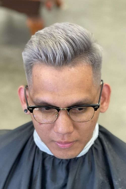 Silver slicked-back undercut with a mid fade